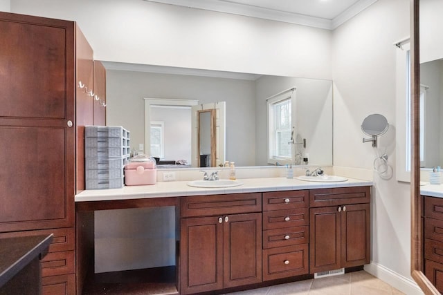 full bathroom featuring double vanity, ornamental molding, a sink, and tile patterned floors