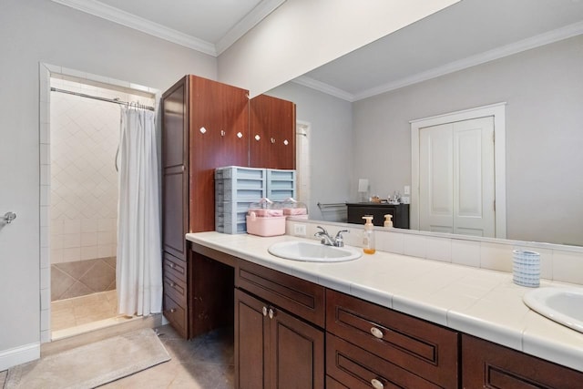 bathroom featuring a sink, ornamental molding, a tile shower, tile patterned floors, and double vanity