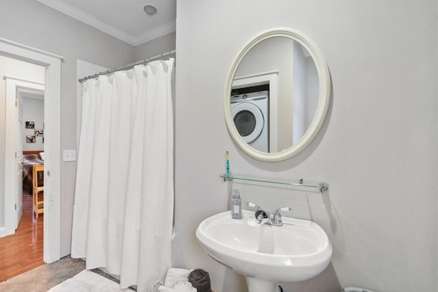 bathroom with ornamental molding, wood finished floors, a sink, and a shower with shower curtain