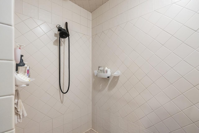 bathroom with tiled shower