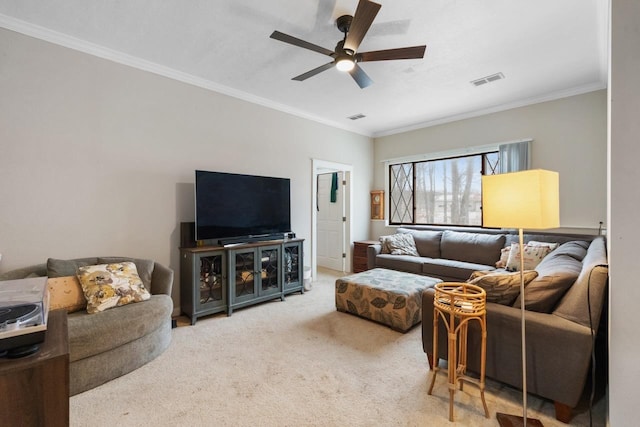 living room featuring ornamental molding, carpet flooring, ceiling fan, and visible vents