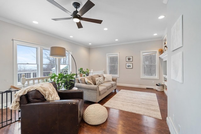 living room featuring baseboards, ornamental molding, and dark wood finished floors