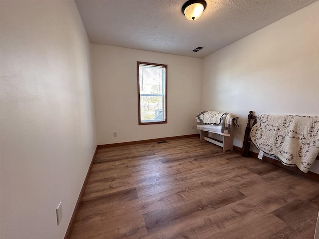 empty room featuring hardwood / wood-style floors and a textured ceiling