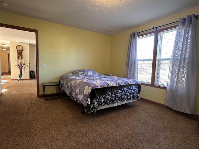 bedroom with carpet flooring and a textured ceiling