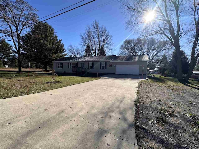 single story home featuring a front lawn and a garage