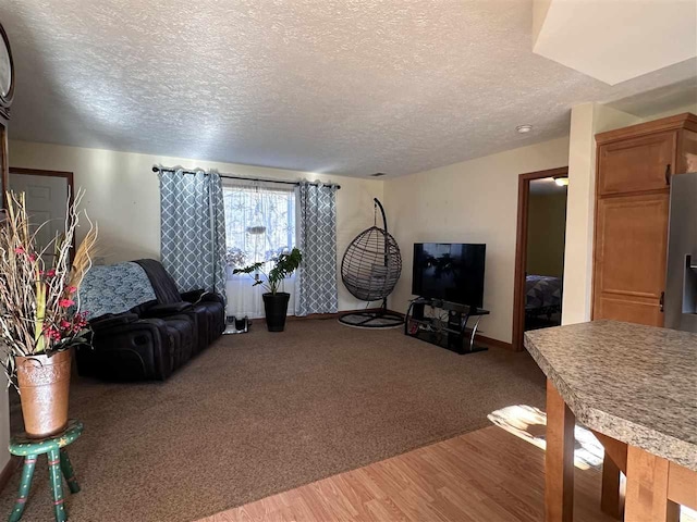 living room with wood-type flooring and a textured ceiling