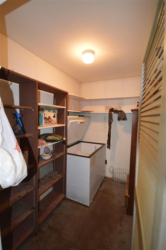 spacious closet featuring dark carpet