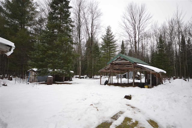 yard covered in snow with a gazebo