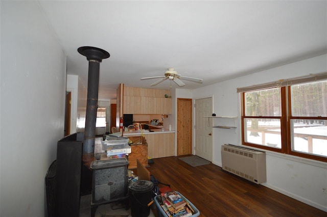 kitchen featuring light brown cabinetry, dark hardwood / wood-style flooring, radiator, and ceiling fan