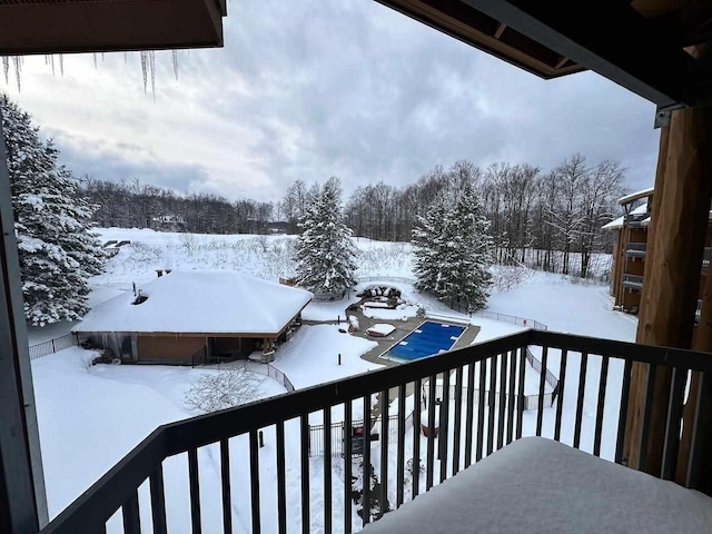 view of snow covered back of property