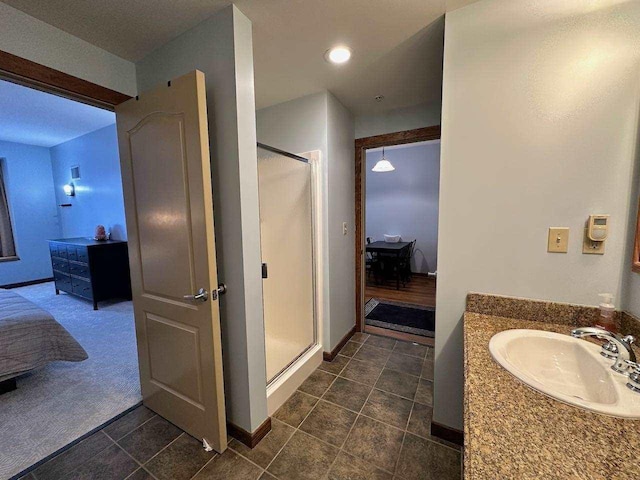 bathroom featuring sink, an enclosed shower, and tile patterned flooring