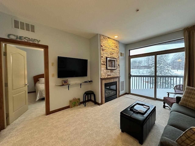 carpeted living room featuring a fireplace