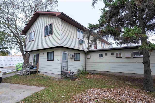 back of property featuring a wall mounted AC