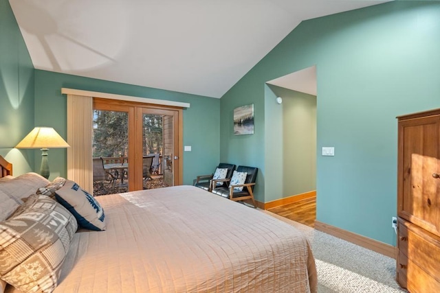 bedroom with access to exterior, lofted ceiling, and light wood-type flooring