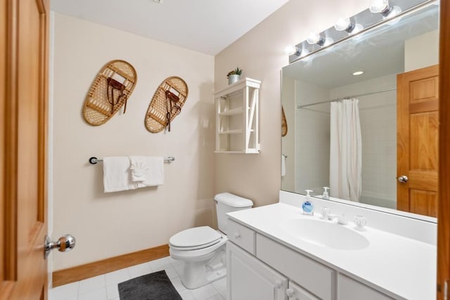 bathroom with tile patterned flooring, vanity, and toilet