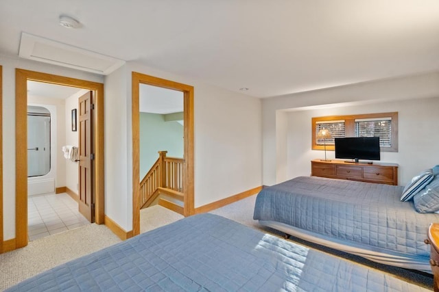 bedroom featuring light carpet and ensuite bath