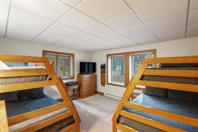 bedroom featuring a drop ceiling, carpet floors, and baseboard heating