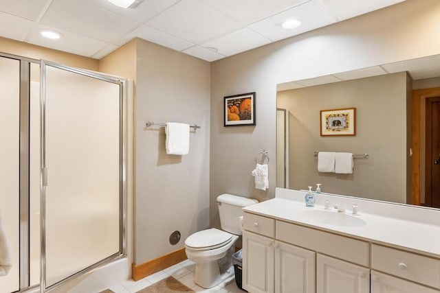 bathroom featuring a paneled ceiling, tile patterned floors, vanity, a shower with door, and toilet