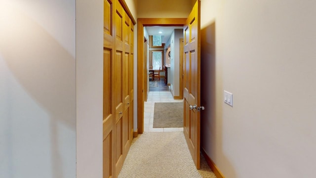 hall featuring light tile patterned floors