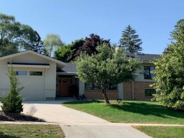 view of front of house with a garage and a front lawn