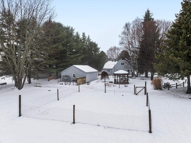 yard covered in snow with an outdoor structure