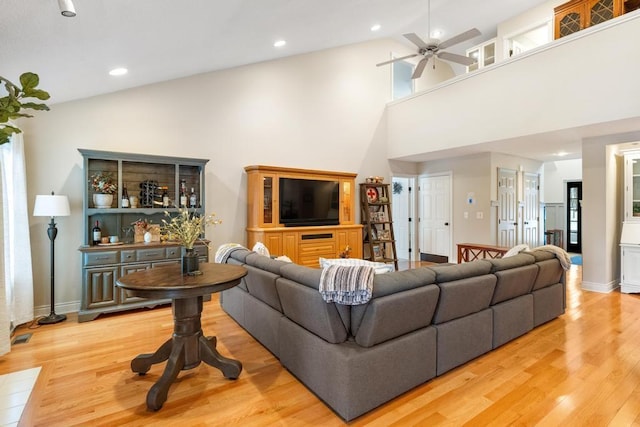 living room with ceiling fan, high vaulted ceiling, and hardwood / wood-style flooring