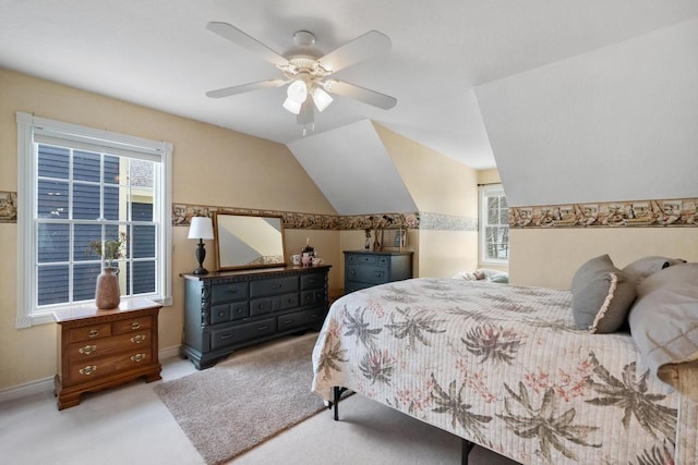 carpeted bedroom with vaulted ceiling and ceiling fan