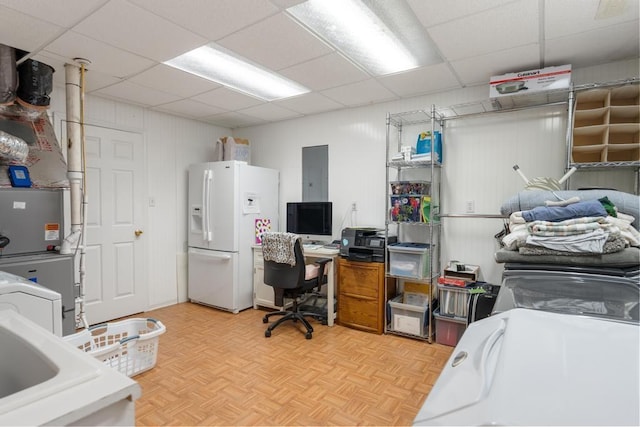 interior space with electric panel, a drop ceiling, and light parquet flooring