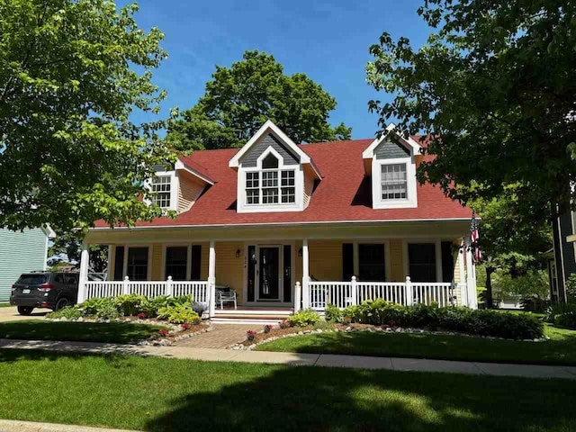 cape cod-style house featuring covered porch