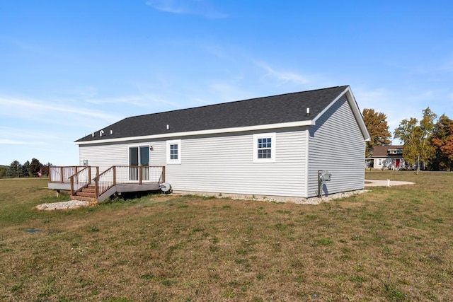 back of property featuring a yard and a wooden deck