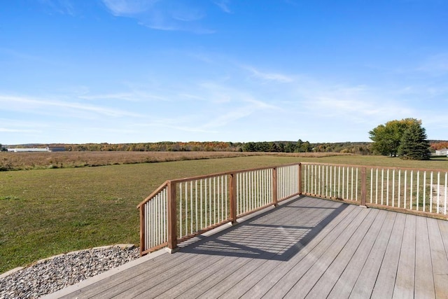 wooden deck with a yard and a rural view