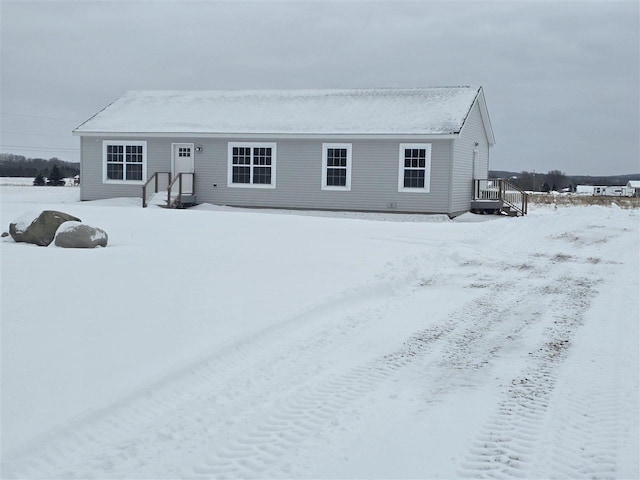 view of snow covered back of property