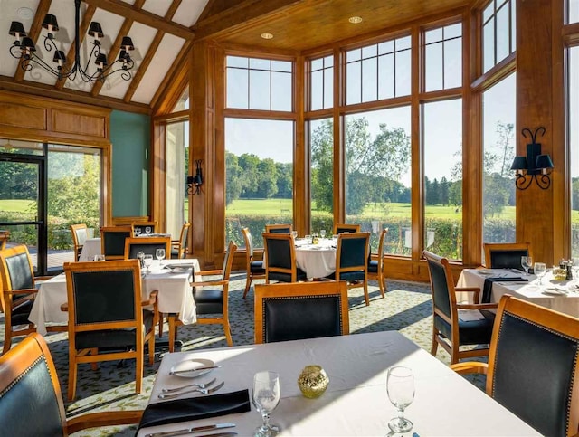 sunroom featuring a notable chandelier and lofted ceiling