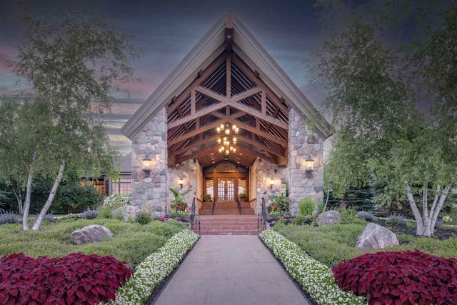 exterior entry at dusk featuring french doors