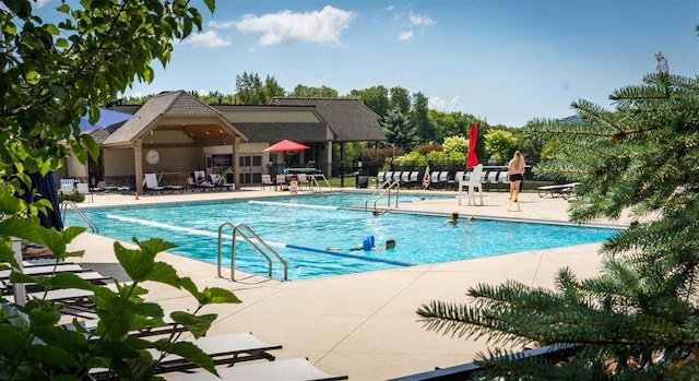 view of swimming pool with a patio area