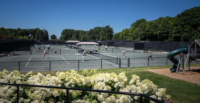 view of sport court with a playground