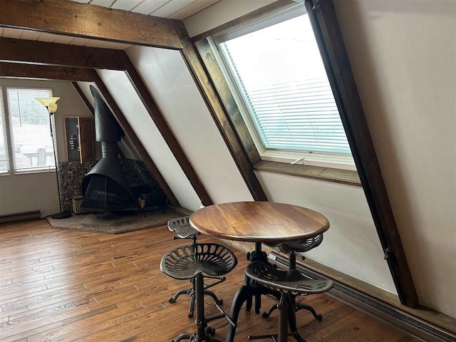 dining area featuring hardwood / wood-style floors, vaulted ceiling with beams, and wood ceiling