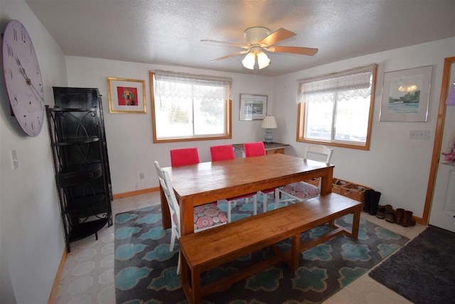 dining space featuring ceiling fan, plenty of natural light, and a textured ceiling