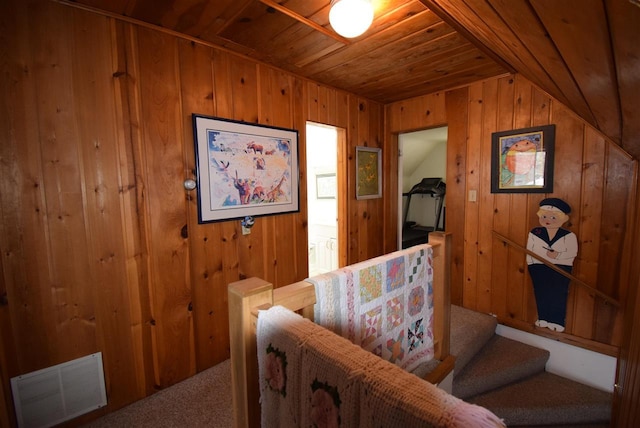 interior space featuring wooden walls, lofted ceiling, and wood ceiling