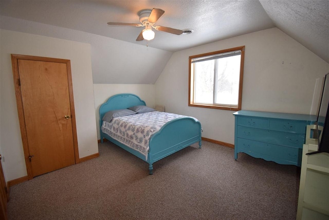 bedroom featuring carpet, a textured ceiling, vaulted ceiling, and ceiling fan