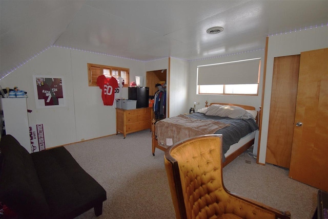 carpeted bedroom featuring lofted ceiling