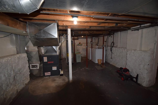 basement featuring washing machine and dryer and gas water heater