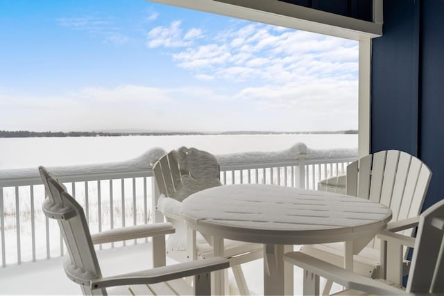 snow covered deck featuring a water view