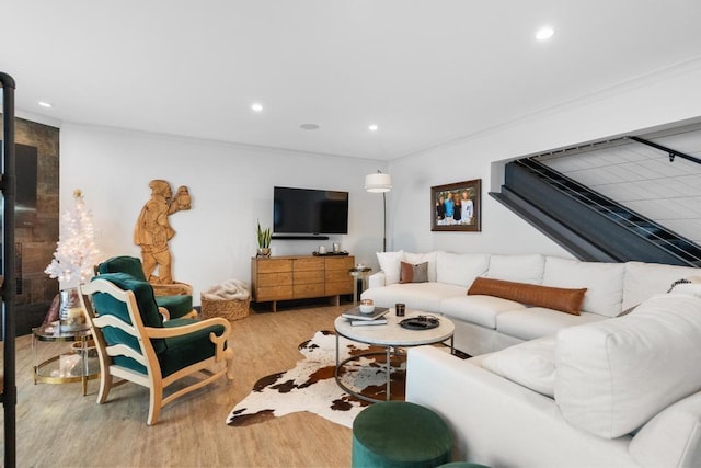 living room featuring light hardwood / wood-style floors and ornamental molding