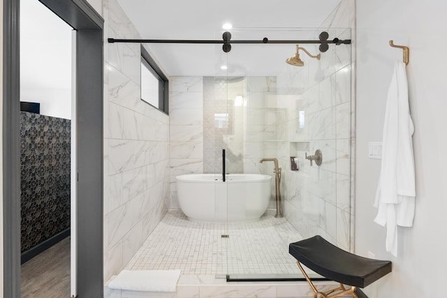 bathroom with separate shower and tub and tile walls