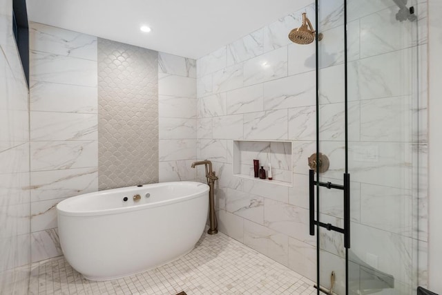 bathroom with plus walk in shower, tile patterned floors, and tile walls