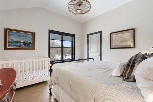 bedroom featuring hardwood / wood-style floors and vaulted ceiling