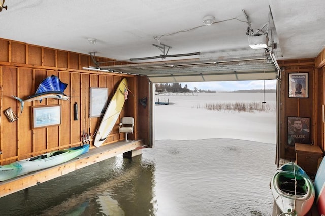 garage with wooden walls and a garage door opener