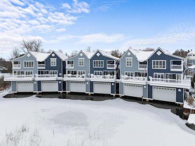 view of snow covered back of property