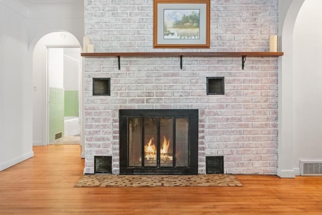 details featuring hardwood / wood-style floors and a fireplace